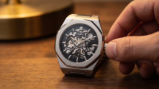 Fingers winding the crown of the DIFFRNT Spine skeleton automatic watch